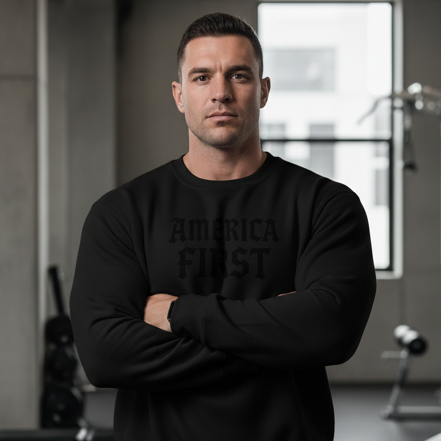 Man wearing a black sweatshirt with 'AMERICA FIRST' text in a gym setting