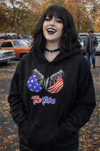 Person wearing a black hoodie with graphic design and text, standing outdoors.