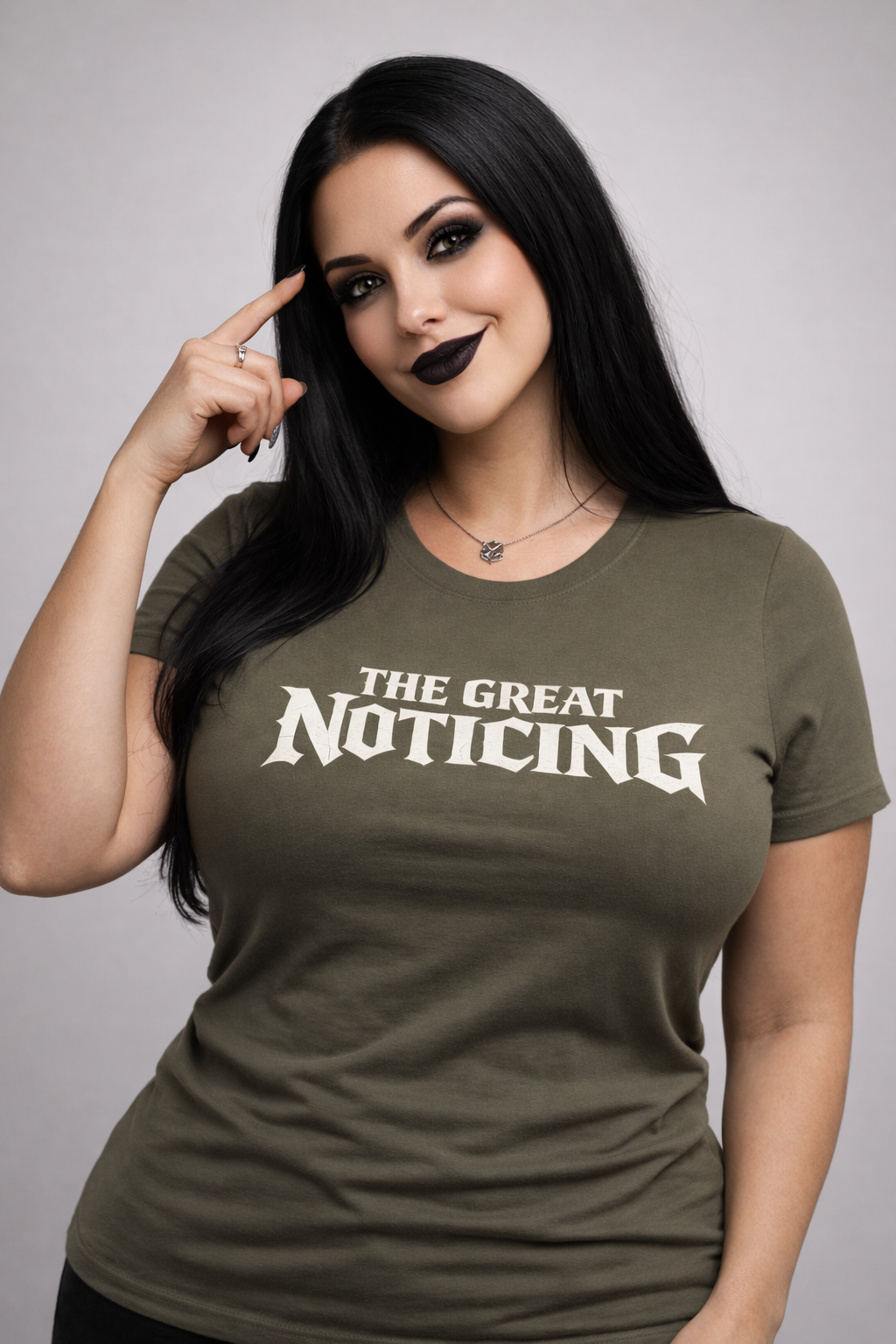 Woman wearing a green t-shirt with 'The Great Noticing' text on a gray background