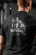 Person lifting weights in a gym wearing a black t-shirt with a logo on the back.
